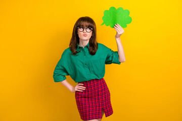 Photo of sweet unsure lady wear green shirt looking speaking cloud empty space isolated yellow color background