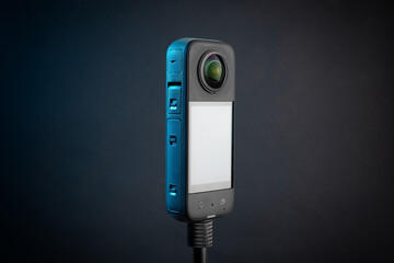 Modern 360 degree digital camera on black background