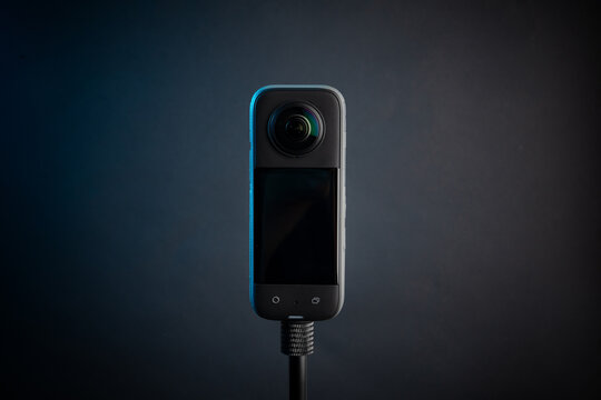 Modern 360 degree digital camera on black background