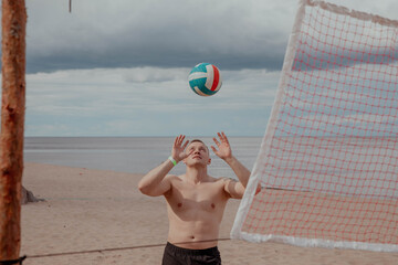 Man playing ball on the beach, volleyball