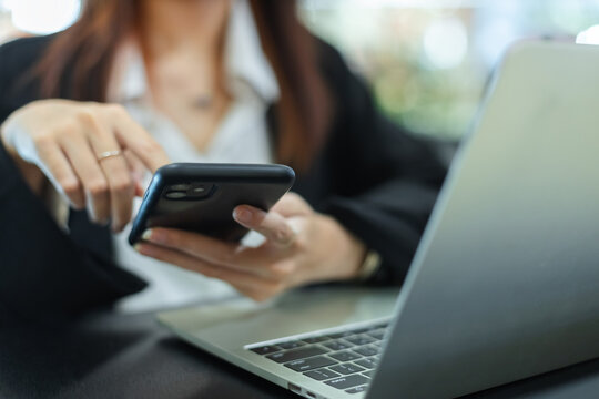Close up mobile phone. asian attractive female business using smartphone sitting office. Space for message design. businesswoman online working with cellphone.