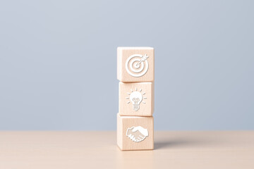 Business growth success achievement. Wooden cube stacked with objective target icons for development and management company  collaboration. Coordinating between organizations for sustainable growth.