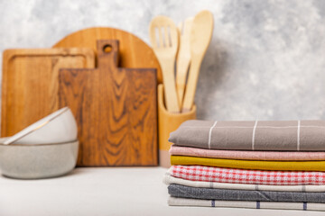 Plakat Kitchen towel. Kitchen utensils and textiles. A stack of cotton towels on the table. Stylish kitchen interior with utensils and crockery on kitchen wooden table.Place for text. copy space.