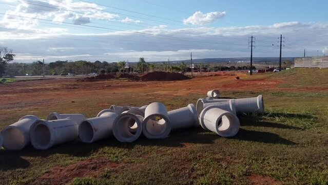 Concrete Sewer pipes laid out on the grass waiting to be installed in the Northwest, neighborhood in Brasilia, Brazil