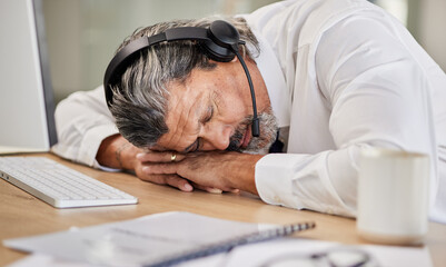 Tired, customer service and male agent sleeping in his office while doing online consultation. Exhausted, burnout and mature man telemarketing or call center consultant taking a nap in the workplace.