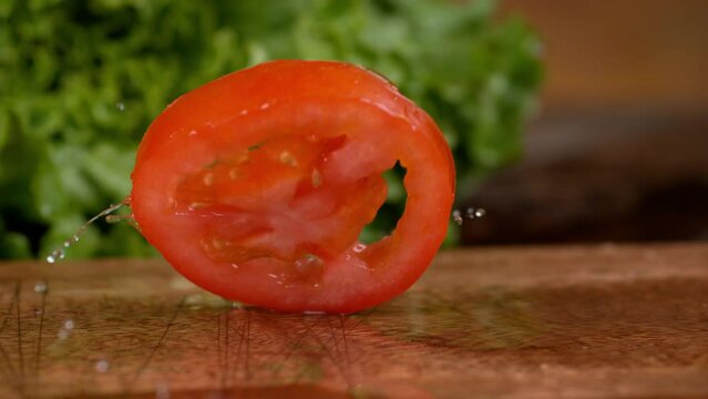 Burger with lettuce and tomato in slow motion