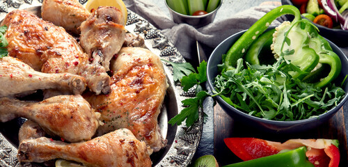 Roasted chicken legs with fresh salads.