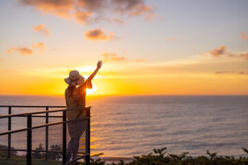 Tourist woman look at the sunset sea view