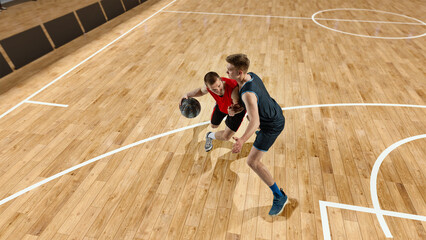 Top view image of two, basketball player in motion during match with ball, competing to win. 3D...