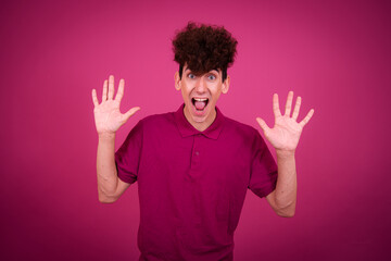 Sports and healthy lifestyle. Funny emotional guy posing on a pink background.