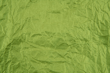 Green crumpled paper texture pattern. Rough grunge old blank.