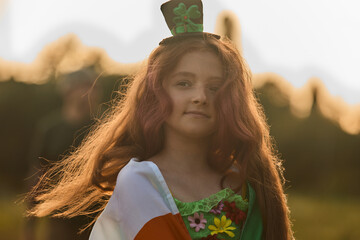 Beautiful redhead girl in a leprechaun hat celebrating St Patricks Day