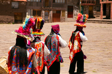 Locals from the island of Taquile in Peru dancing at an event in the main square of the island.