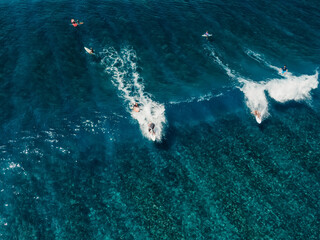 Aerial view with surfing on wave. Perfect waves with surfers in tropical ocean