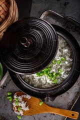 Wholesome Fusion: Top Close-Up of Edamame Served on Steamed White Rice in a Cast Iron Pot, Captured in 4K Resolution