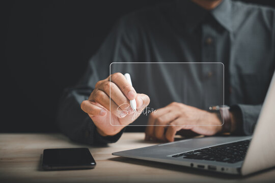 Closeup of businessman hand with stylus signing digital documents. Embracing digital transformation, this stock photo represents efficient business contract signing. Paperless office is focus.