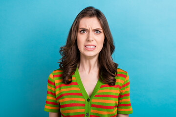 Photo of pretty aggressive dissatisfied girl with curly hairstyle wear striped shirt clenching...
