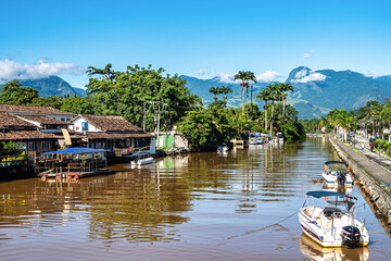 Colourful boats moored along the waterfront of Ponte do Pontal at Paraty, Brazil