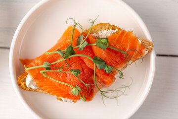 Sandwich with red fish and pea sprouts