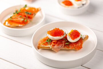 Sandwich with red fish, boiled egg and red caviar
