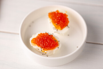 Boiled egg with red caviar