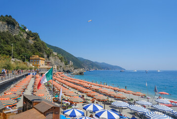 orange beach umbrellas on the beach of Monterosso, Cinque Terre, The Ligurian Sea, Liguria, Italy, Italian Riviera