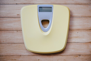Top view of an old digital scales on wooden floor.