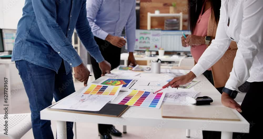 Poster designer group at desk discussing custom house