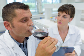 wine specialist tasting red wine in the lab