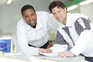 two workers professionally paint walls for living