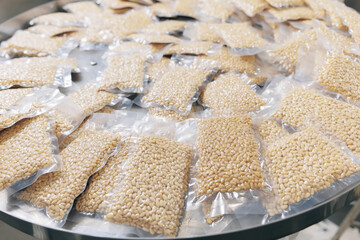 Production vacuum packed cedar nuts on automatic conveyor belt for transporting. Concept food industry plant