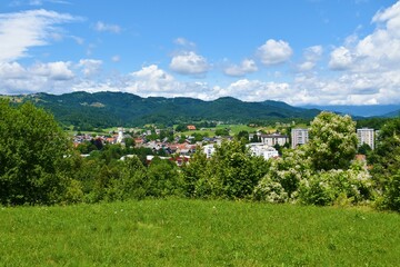 Fototapeta na wymiar View of Skofja Loka town and forest covered hills above in Gorenjska, Slovenia