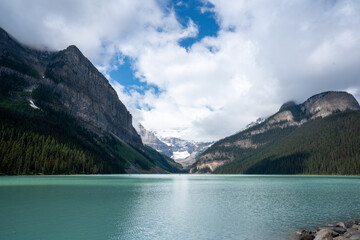 Beautiful glacial mountain lake with snow capped mountains 2