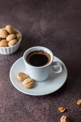 cup of coffee and cookies on a dark background, close up