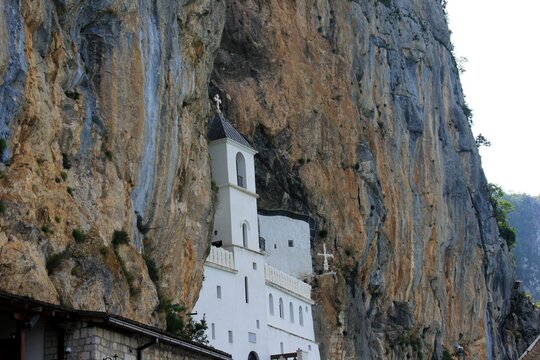 Ostrog, Montenegro - June 26, 2023: Old Ostrog monastery is the most popular pilgrimage place in Montenegro. ancient orthodox monastery in Montenegro