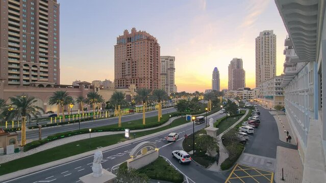 Street traffic at beautiful cityscape of west bay doha city at sunset