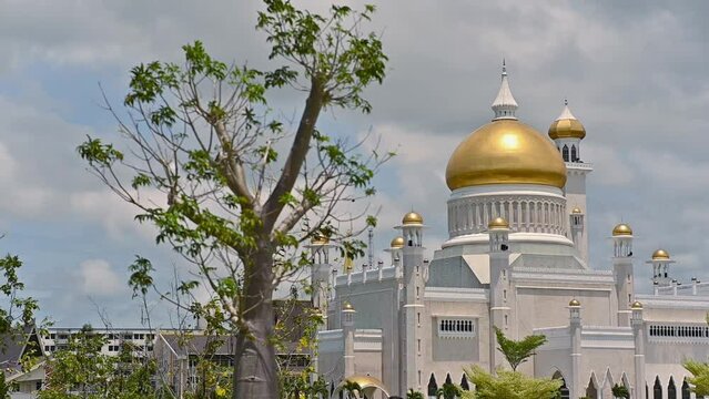The late afternoon sun sets over Bandar Seri Begawan, Brunei, and strikes the facade of the Sultan Omar Ali Saifuddin Mosque.