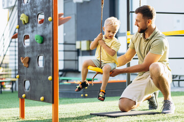 Obraz premium Father with son playing at the playground