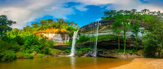 Panorama view of Native picturesque waterfall,Big Waterfall in deep forest , Huai Luang Waterfal Ubon Ratchathani, Thailand ,is popular with waterfall tourists.leaf moving low speed shutter blur.