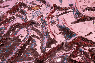 Sequin fabric  for party dresses, creative pastel pink background. 