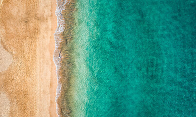 Beach with turquoise water on Fuerteventura island, Spain, Canary islands. Aerial view of sand beach, ocean texture background, top down view of beach by drone. Fuerteventura, Spain, Canary islands.