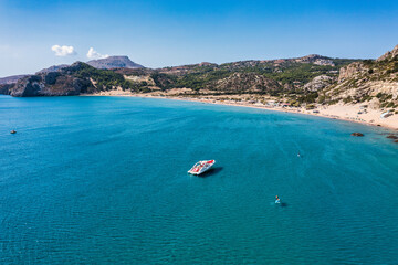 Tsampika beach with golden sand view from above, Rhodes, Greece. Aerial birds eye view of famous beach of Tsampika, Rhodes island, Dodecanese, Greece