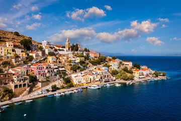 Aerial view of the beautiful greek island of Symi (Simi) with colourful houses and small boats. Greece, Symi island, view of the town of Symi (near Rhodes), Dodecanese.