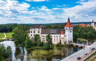 Fototapeta na wymiar Blatna castle near Strakonice, Southern Bohemia, Czech Republic. Aerial view of medieval Blatna water castle surrounded parks and lakes, Blatna, South Bohemian Region, Czech Republic.