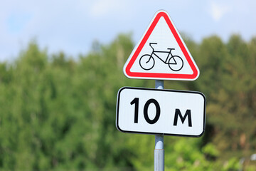 Information board or road sign for cyclists on the street on a summer day