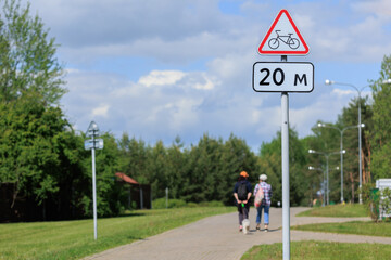 Information board or road sign for cyclists on the street on a summer day - obrazy, fototapety, plakaty