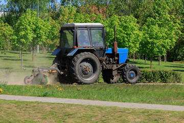 Agricultural tractor on the grass on a sunny day