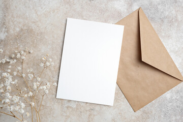 Wedding invitation card mockup with craft envelope and copy space for card design, flat lay
