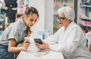 Pharmacist giving advice And advice for patients who come to buy Medicine, Drugs, Vitamins products, according to prescriptions in modern pharmacies.