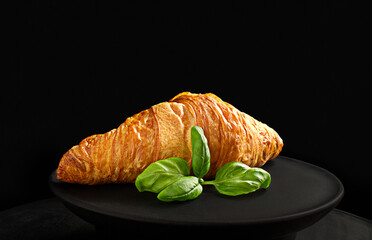 golden crispy ruddy croissant on a dark background